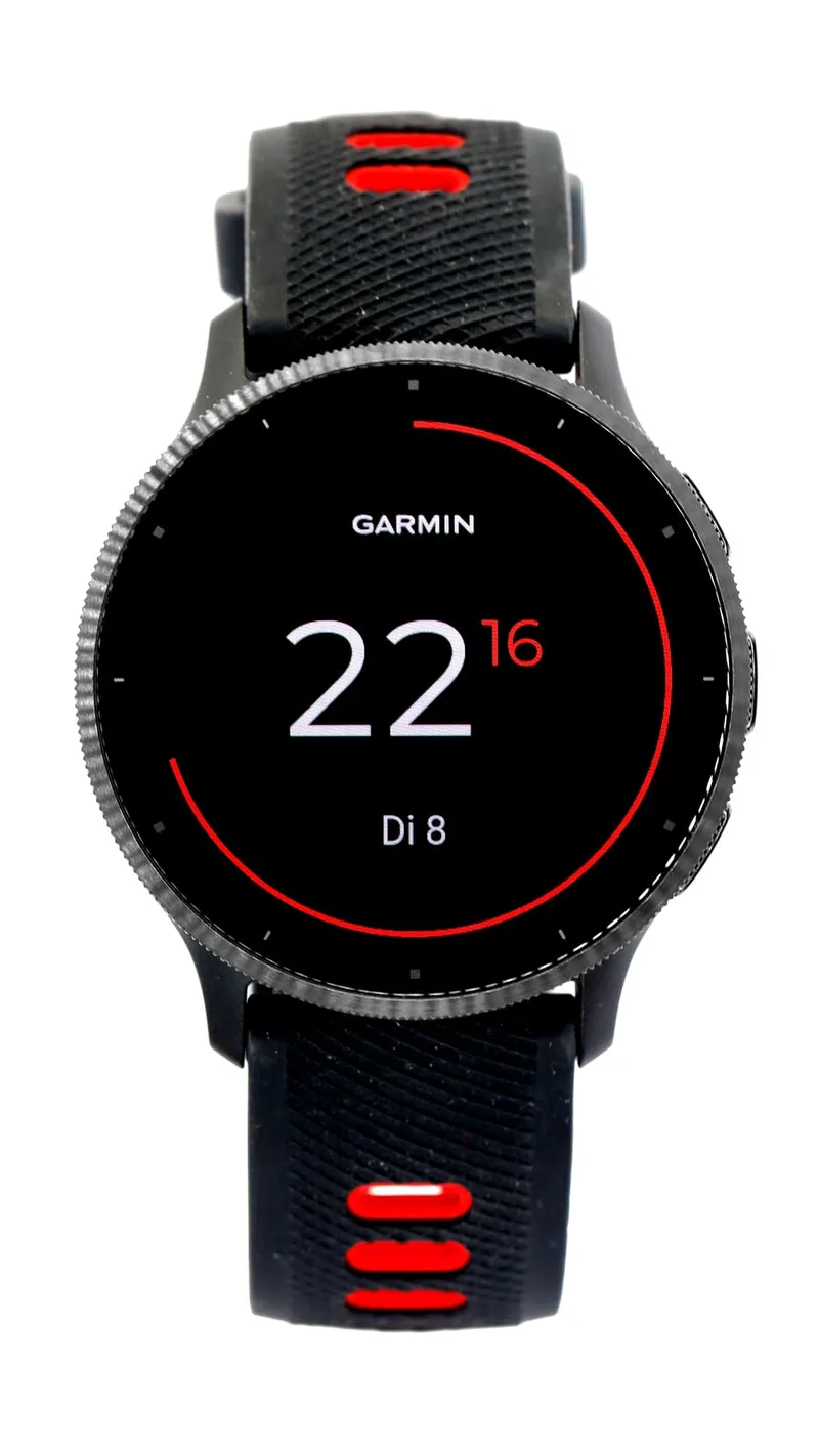 A Garmin Venu 3 with a black case, a ridged bezel and a black strap with red accents, showing a red ring watch face.
